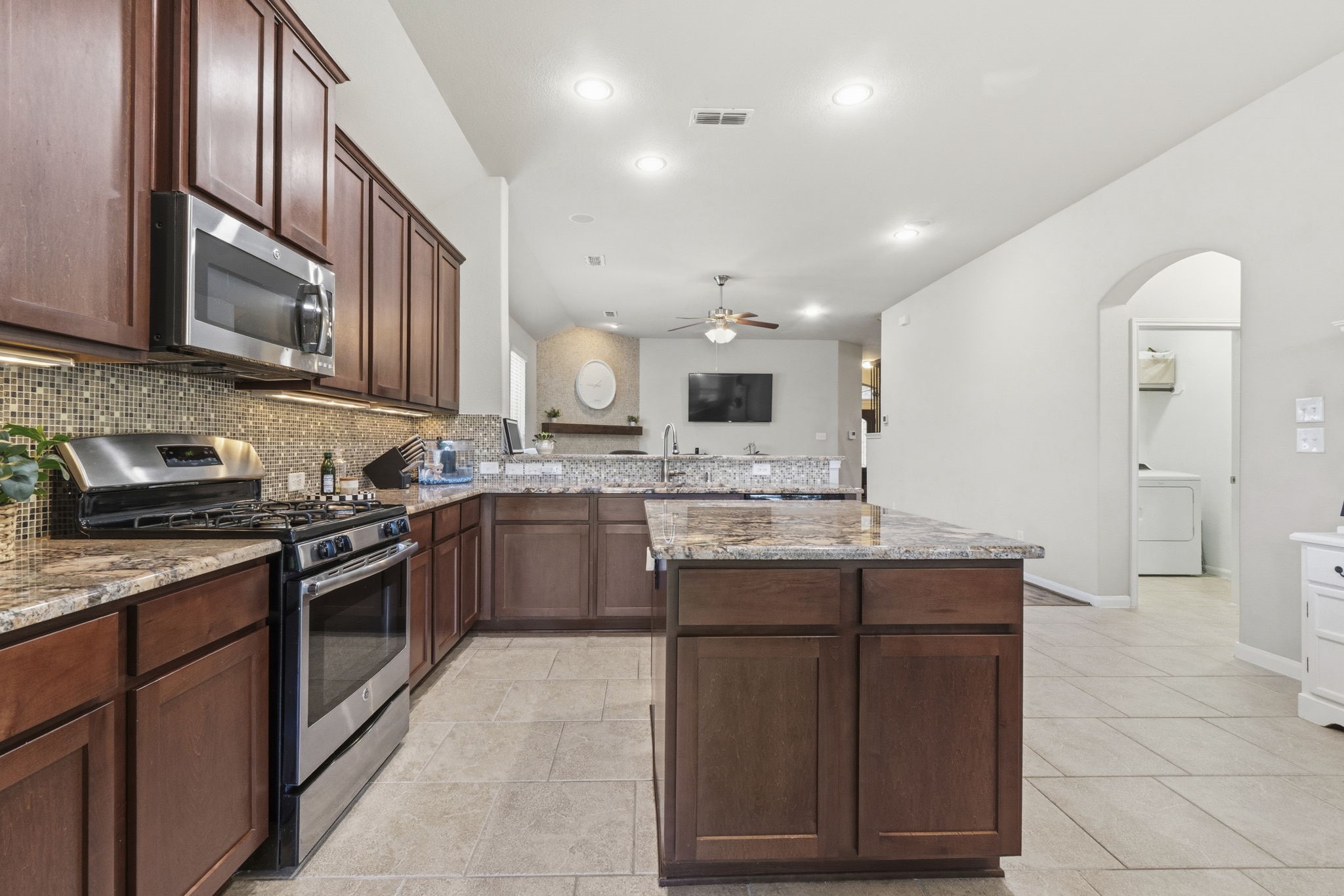 3900 Enchanted Timbers Lane Spring, TX 77386 - Photo 14 of 49 a kitchen with stainless steel appliances granite countertop a stove and a sink