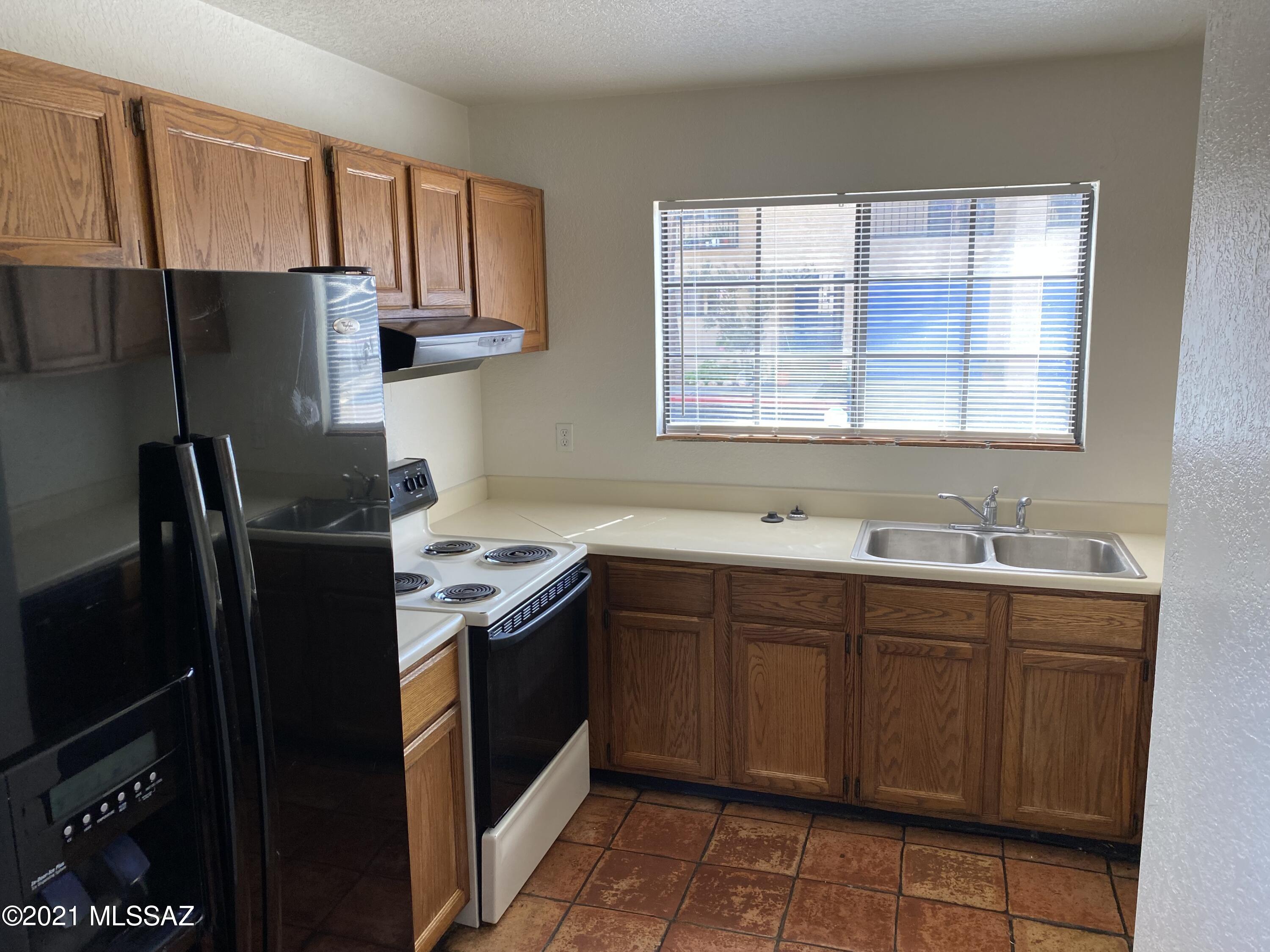 210 East Pastime Road Tucson, AZ 85705 - Photo 15 of 29 a kitchen with stainless steel appliances granite countertop a refrigerator and a sink
