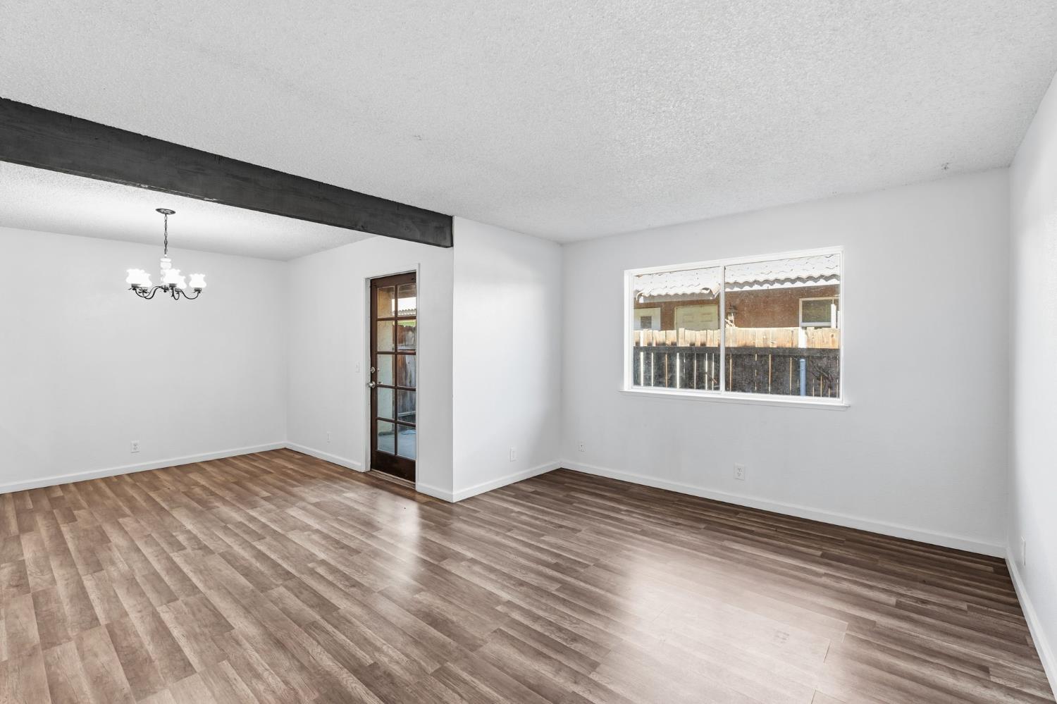 50 North 19th Avenue, Unit AF Lemoore, CA 93245 - Photo 12 of 40 a view of empty room with wooden floor and fan
