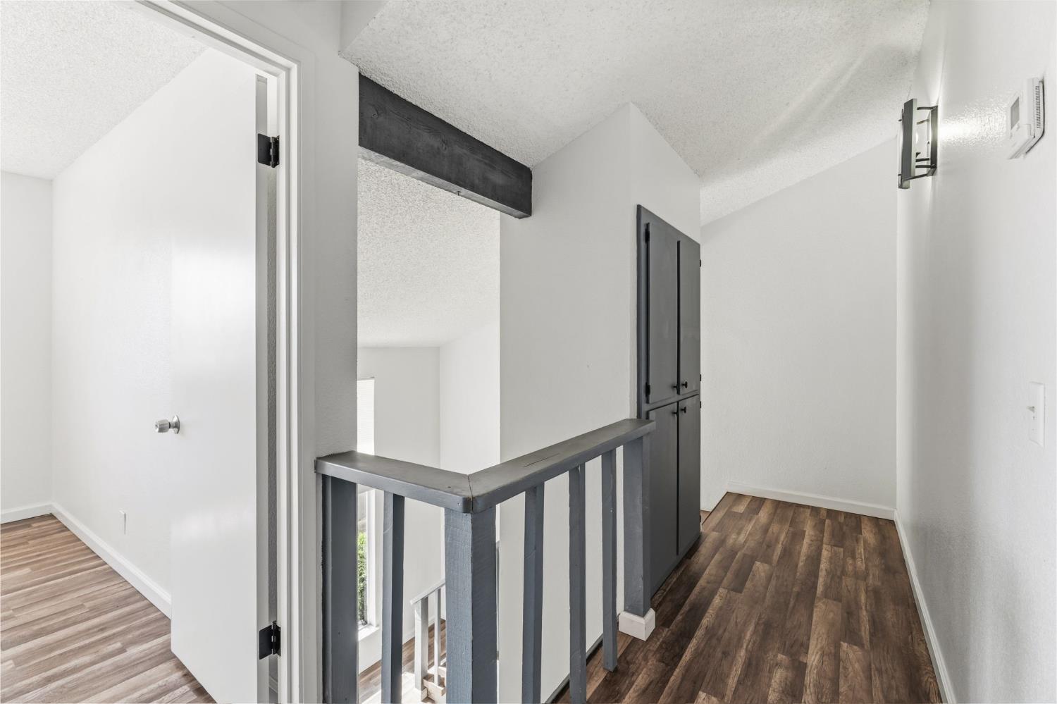 50 North 19th Avenue, Unit AF Lemoore, CA 93245 - Photo 13 of 40 a view of a hallway with wooden floor and staircase