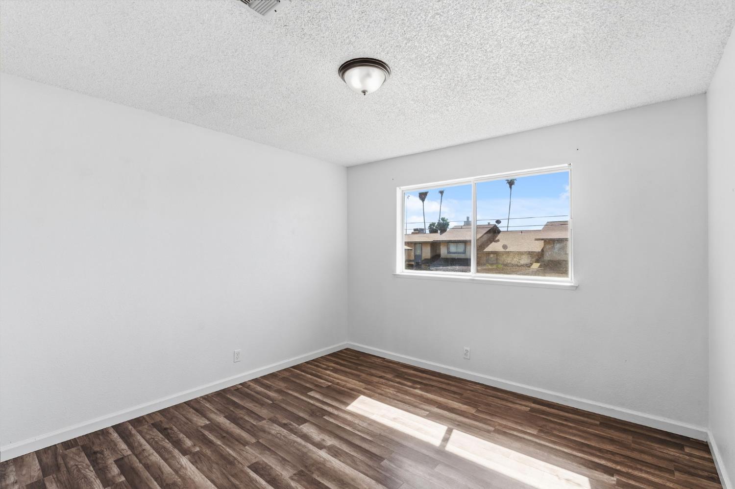 50 North 19th Avenue, Unit AF Lemoore, CA 93245 - Photo 14 of 40 a view of a room with wooden floor and window