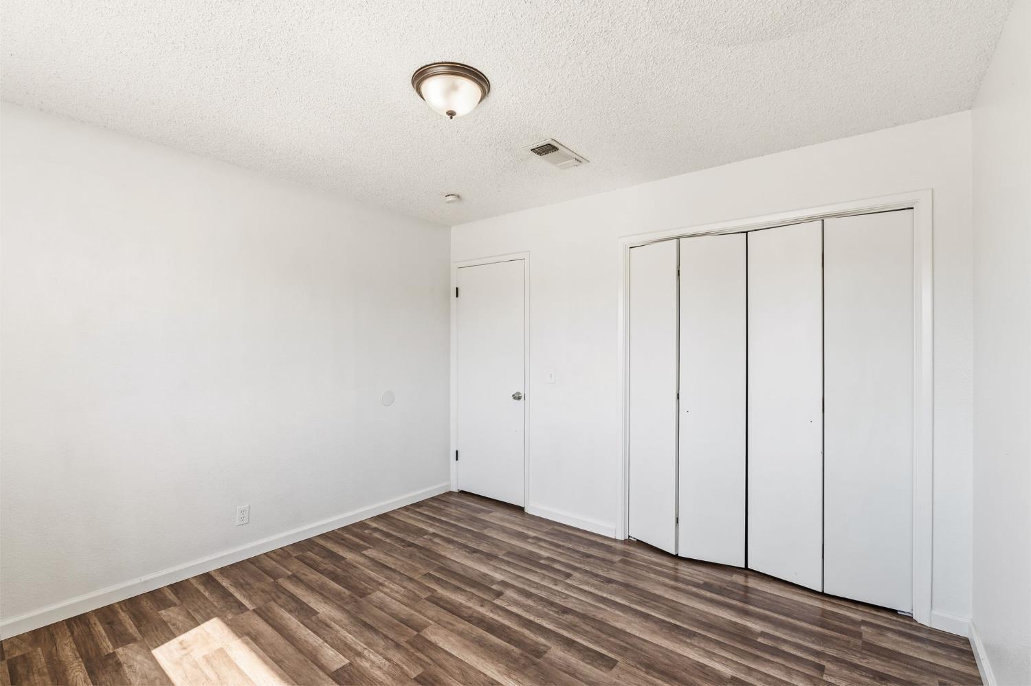 50 North 19th Avenue, Unit AF Lemoore, CA 93245 - Photo 15 of 40 a view of a room with wooden floor