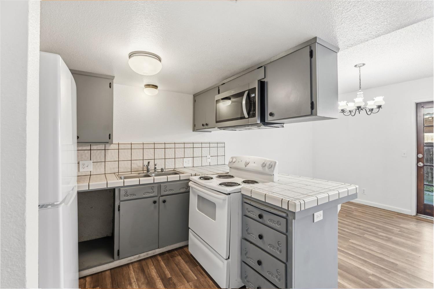 50 North 19th Avenue, Unit AF Lemoore, CA 93245 - Photo 2 of 40 a kitchen with a sink stove and microwave