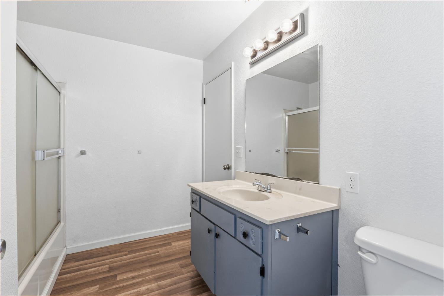 50 North 19th Avenue, Unit AF Lemoore, CA 93245 - Photo 21 of 40 a utility room with a sink a toilet and vanity