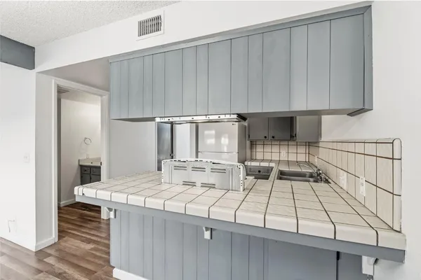 a kitchen with a sink and cabinets