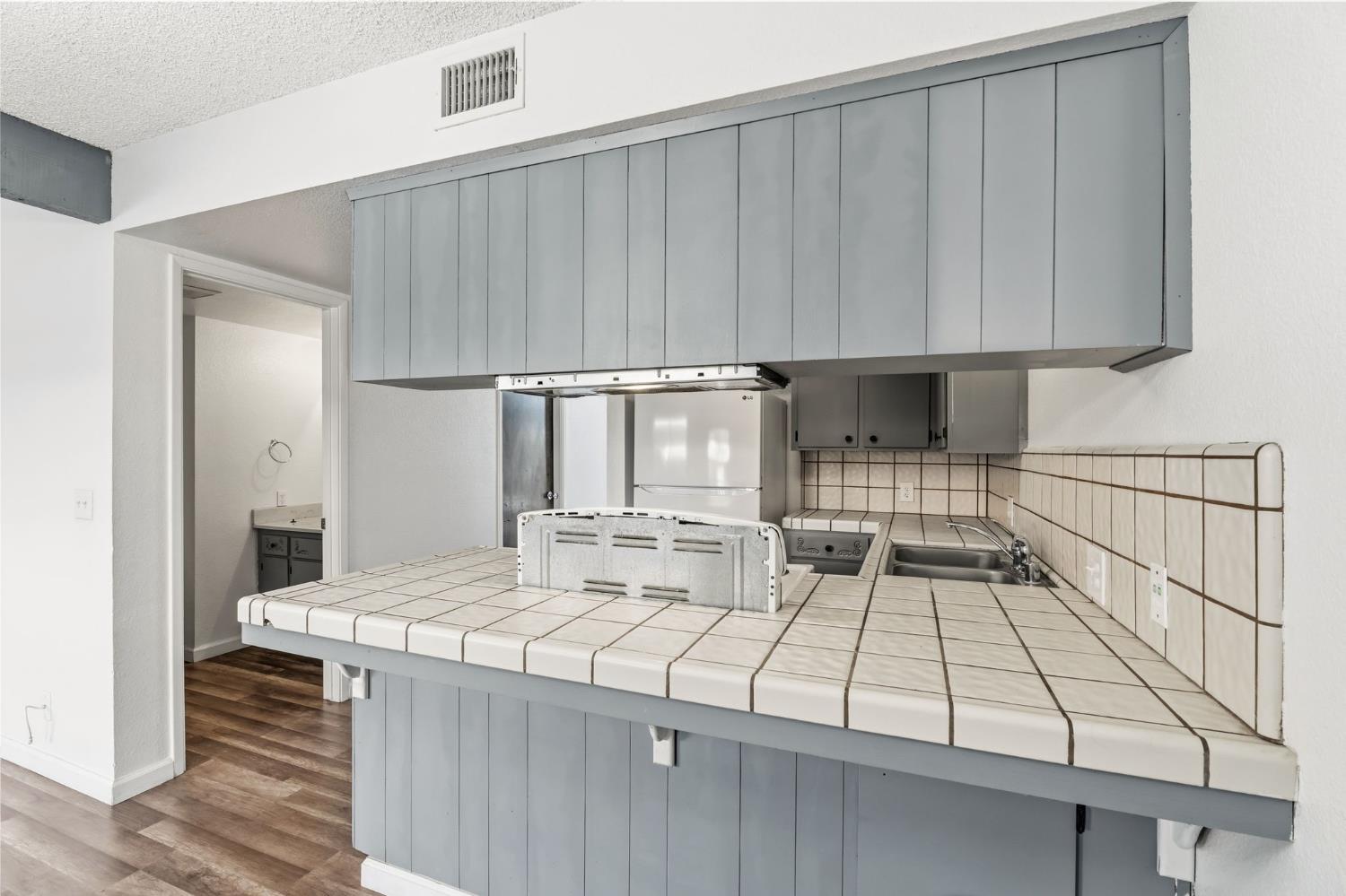50 North 19th Avenue, Unit AF Lemoore, CA 93245 - Photo 4 of 40 a kitchen with a sink and cabinets