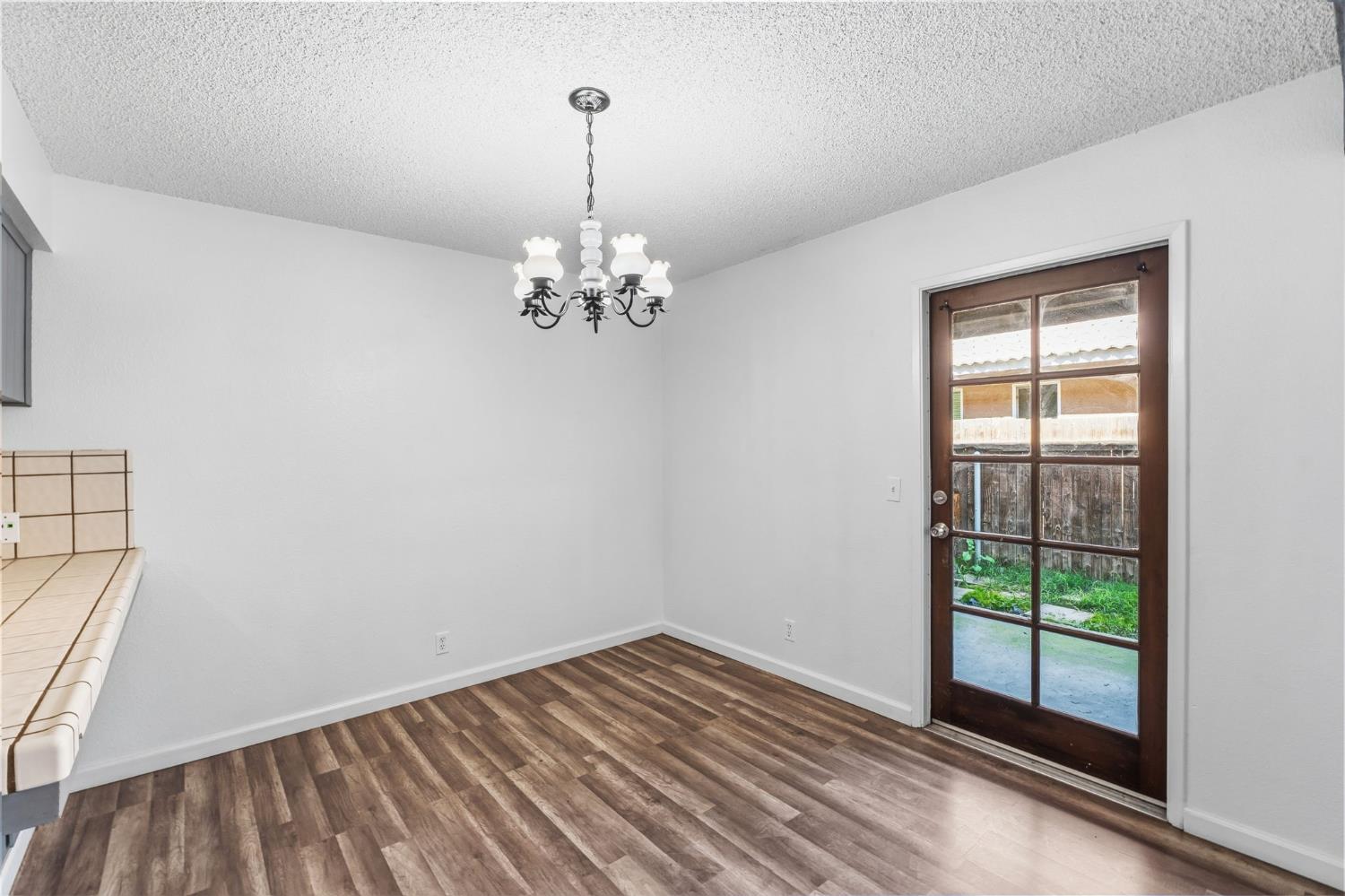 50 North 19th Avenue, Unit AF Lemoore, CA 93245 - Photo 7 of 40 a view of empty room with wooden floor and fan