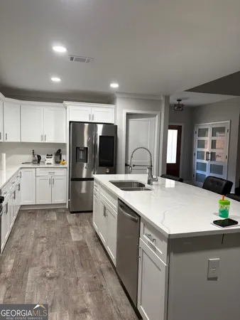 a kitchen with a sink appliances and cabinets