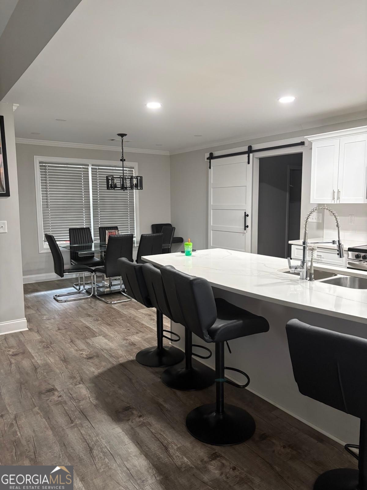 606 Old River Road Cornelia, GA 30531 - Photo 20 of 27 a kitchen with a sink dining table and chairs