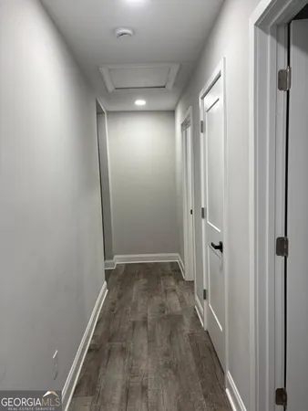 a view of hallway with wooden floor