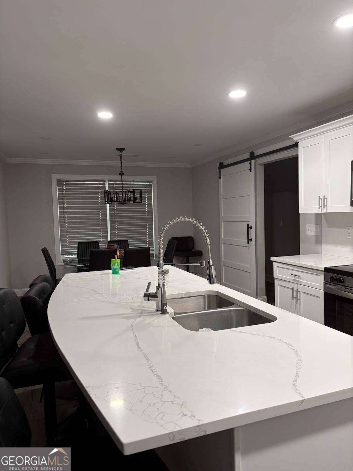 606 Old River Road Cornelia, GA 30531 - Photo 6 of 27 a kitchen with kitchen island a stove a sink a refrigerator and chairs