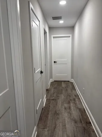 a view of a room with wooden floor