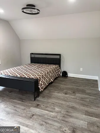 a bedroom with a bed and a night stand