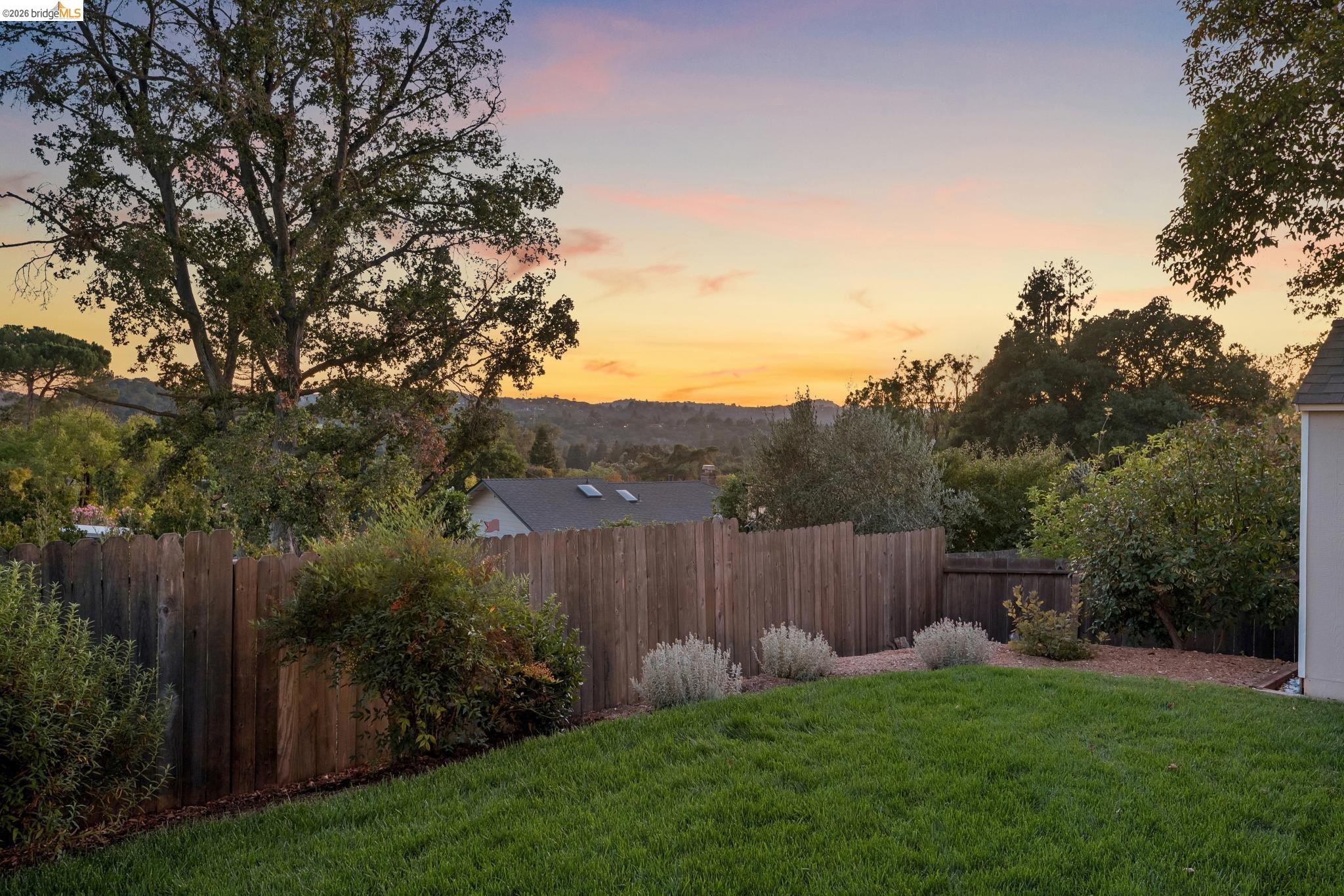 1321 Sunset Loop Lafayette, CA 94549 - Photo 48 of 49 Expansive backyard featuring a green lawn, wood fence, and mature trees