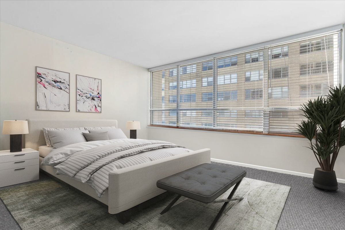 6171 North Sheridan Road, Unit 1112 Chicago, IL 60660 - Photo 12 of 23 a living room with a bed furniture and a large window