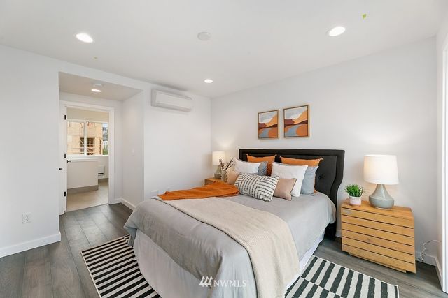 a bedroom with a bed and a painting