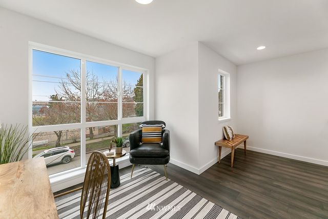 a view of a livingroom with furniture and a window