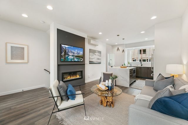 a living room with furniture a rug and a fireplace