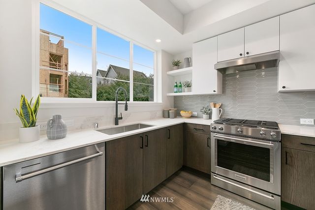 a kitchen with a sink stove and cabinets