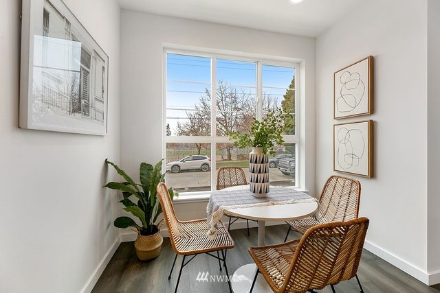 a view of a dining room with furniture window and wooden floor
