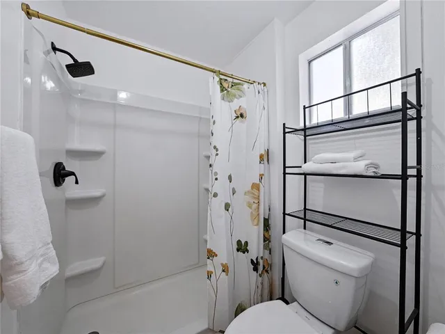 a spacious bedroom with a bed and a couch