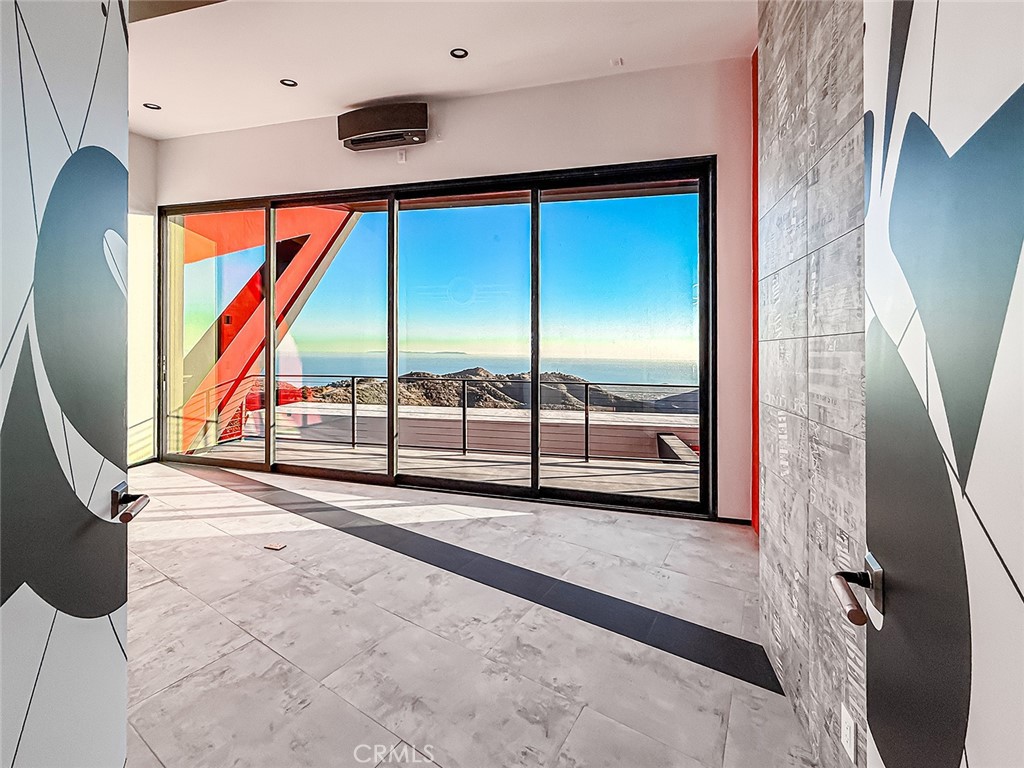 2514 Cayman Road Malibu, CA 90265 - Photo 40 of 73 a view of an empty room with wooden floor and windows