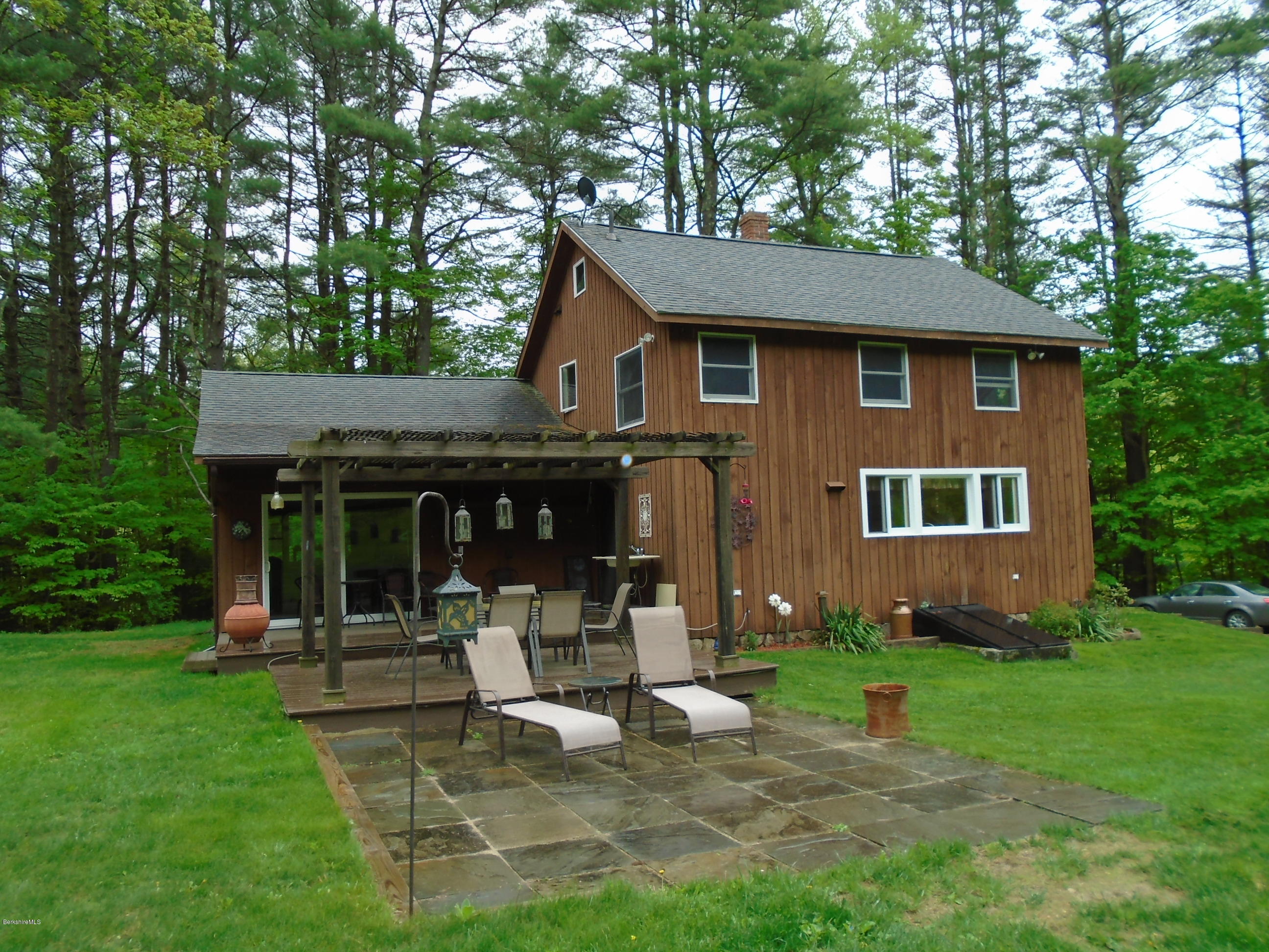 1350 South Main Road Otis, MA 01253 - Photo 2 of 56 a front view of a house with garden