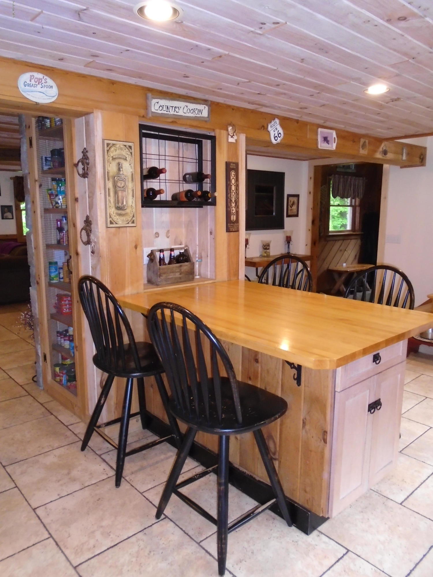 1350 South Main Road Otis, MA 01253 - Photo 14 of 56 a view of a dining room with furniture and a chandelier
