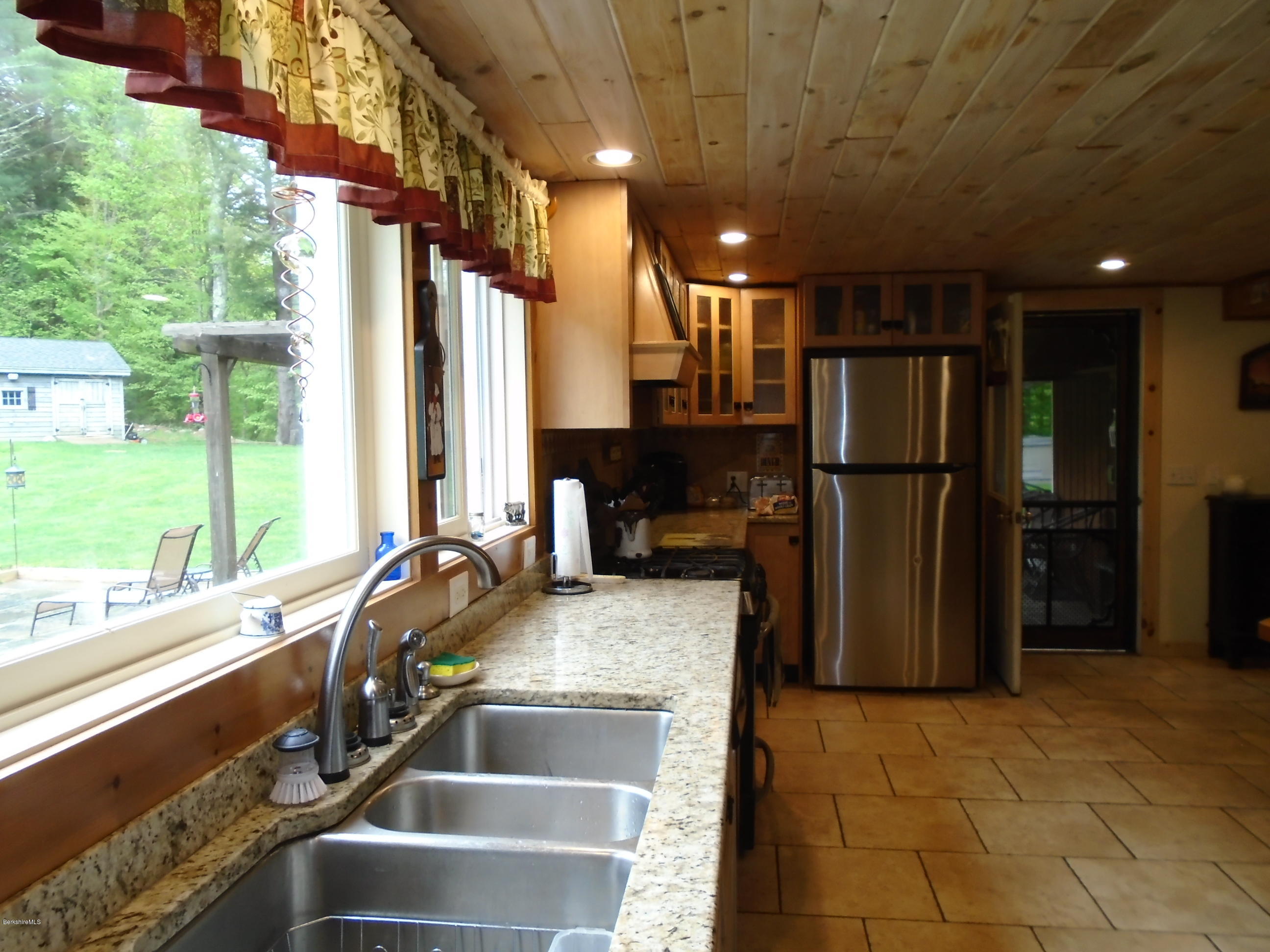 1350 South Main Road Otis, MA 01253 - Photo 24 of 56 a kitchen with stainless steel appliances granite countertop a refrigerator and a sink