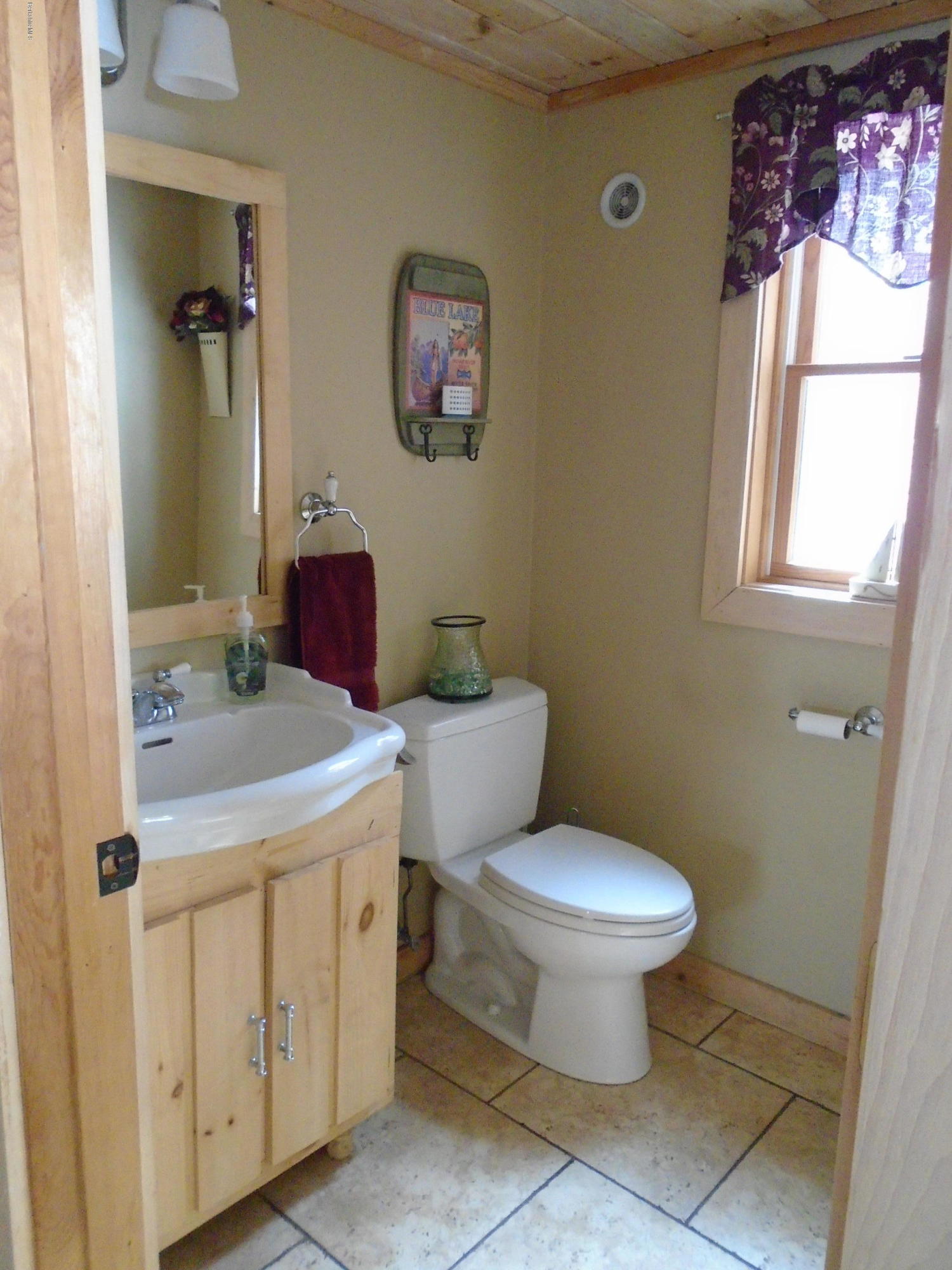 1350 South Main Road Otis, MA 01253 - Photo 29 of 56 a bathroom with a toilet sink and mirror