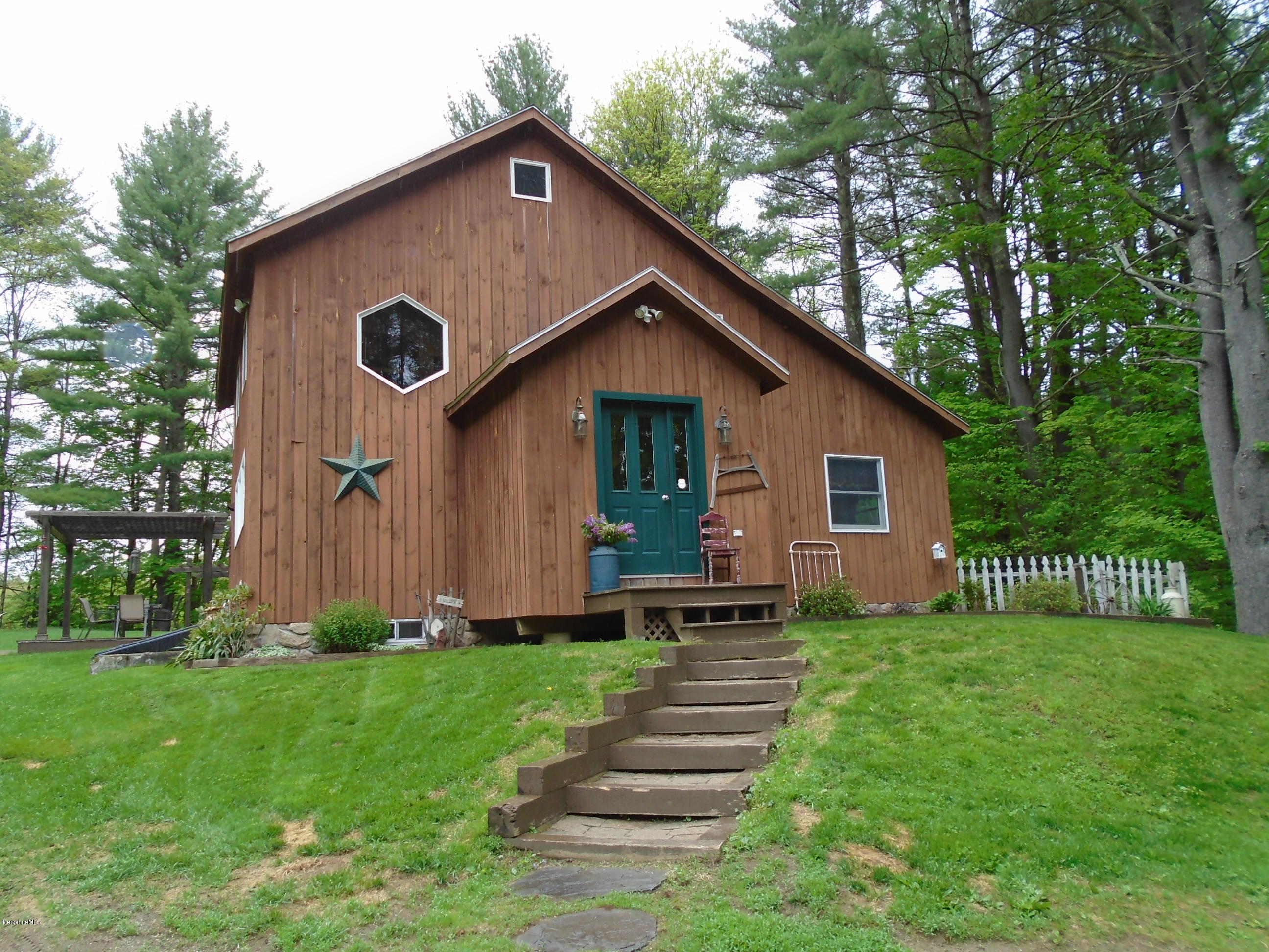 1350 South Main Road Otis, MA 01253 - Photo 4 of 56 a front view of a house with garden
