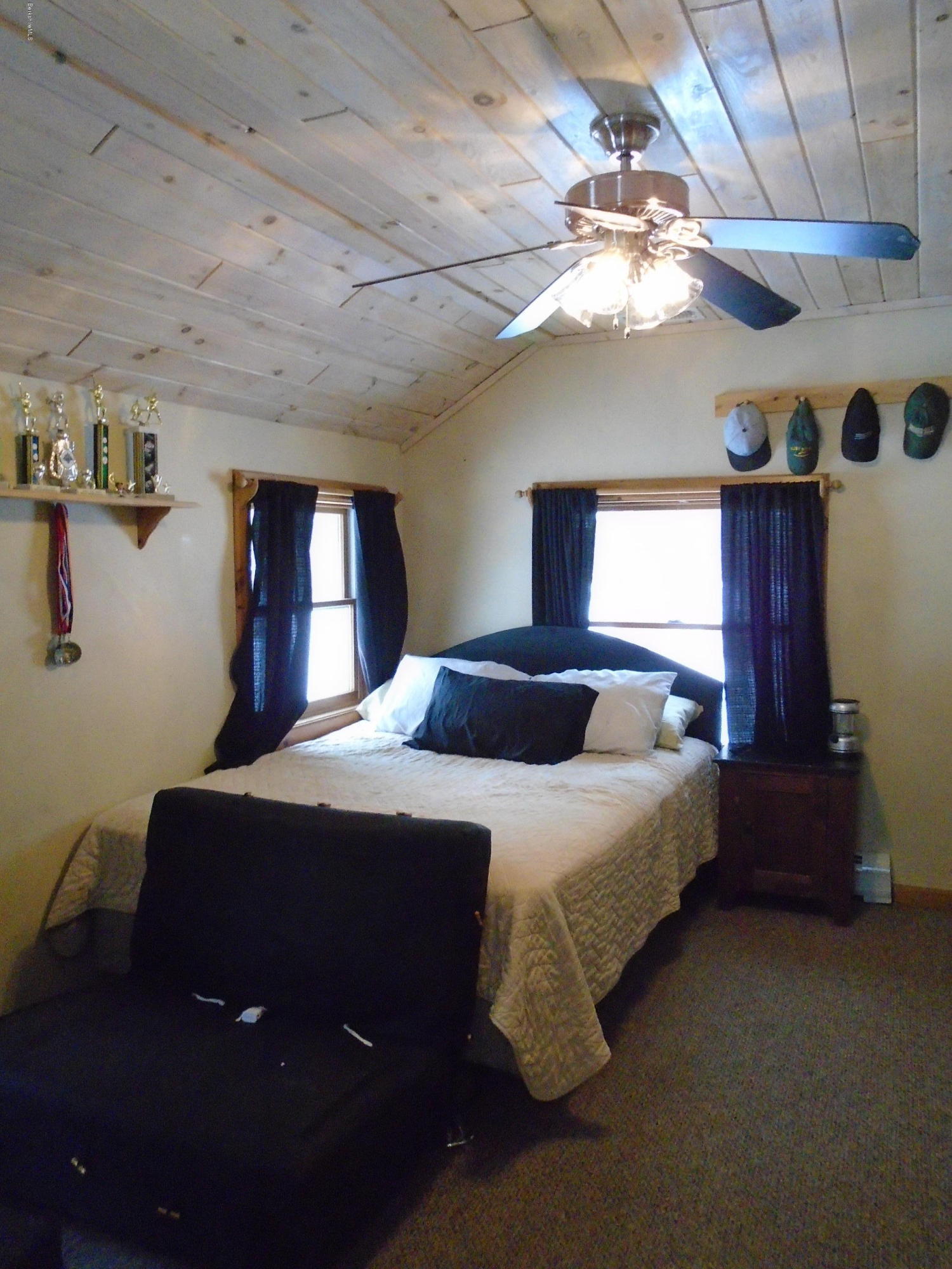 1350 South Main Road Otis, MA 01253 - Photo 43 of 56 a bedroom with a bed and a chandelier