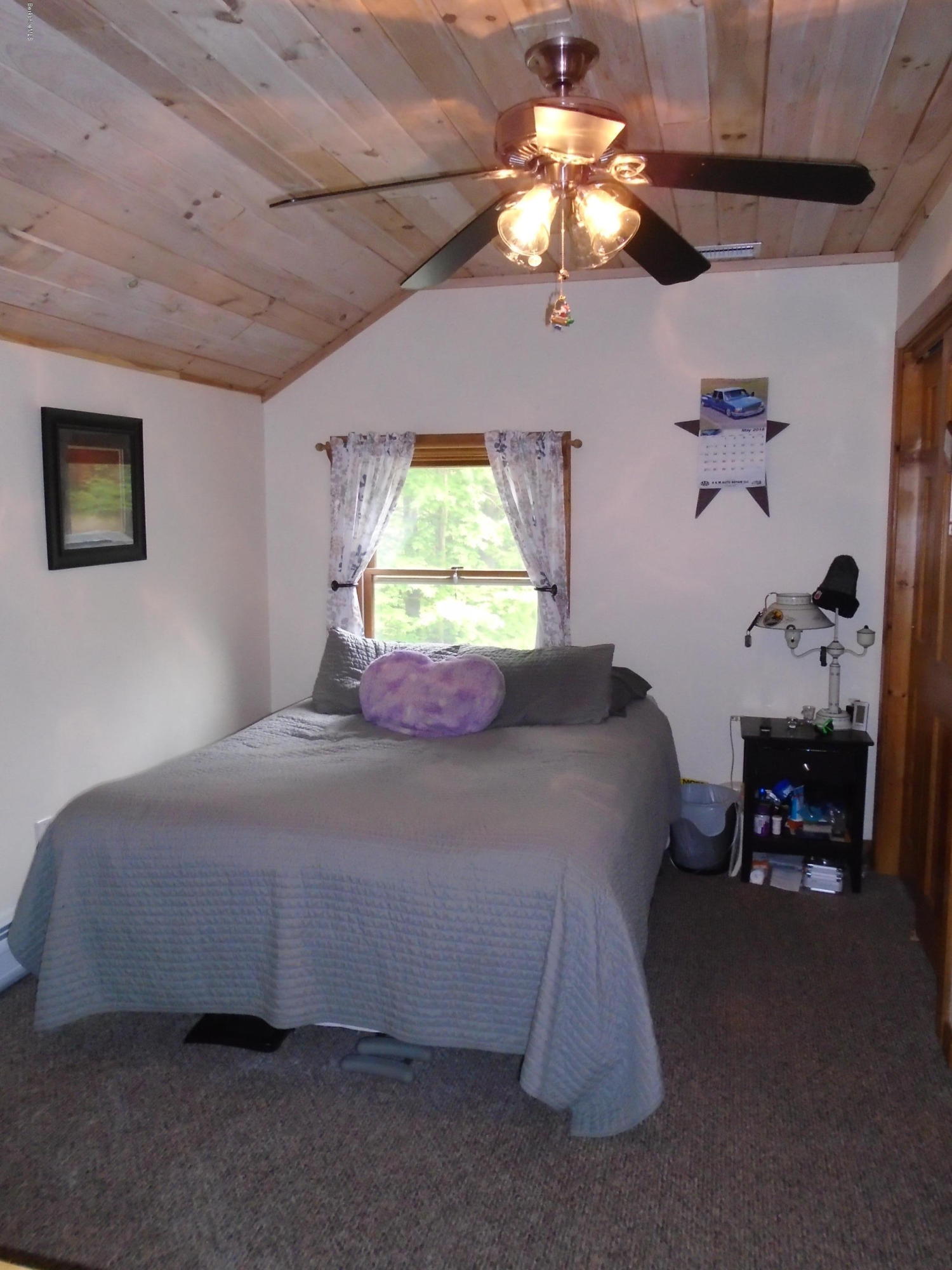 1350 South Main Road Otis, MA 01253 - Photo 44 of 56 a bedroom with a bed and a chandelier