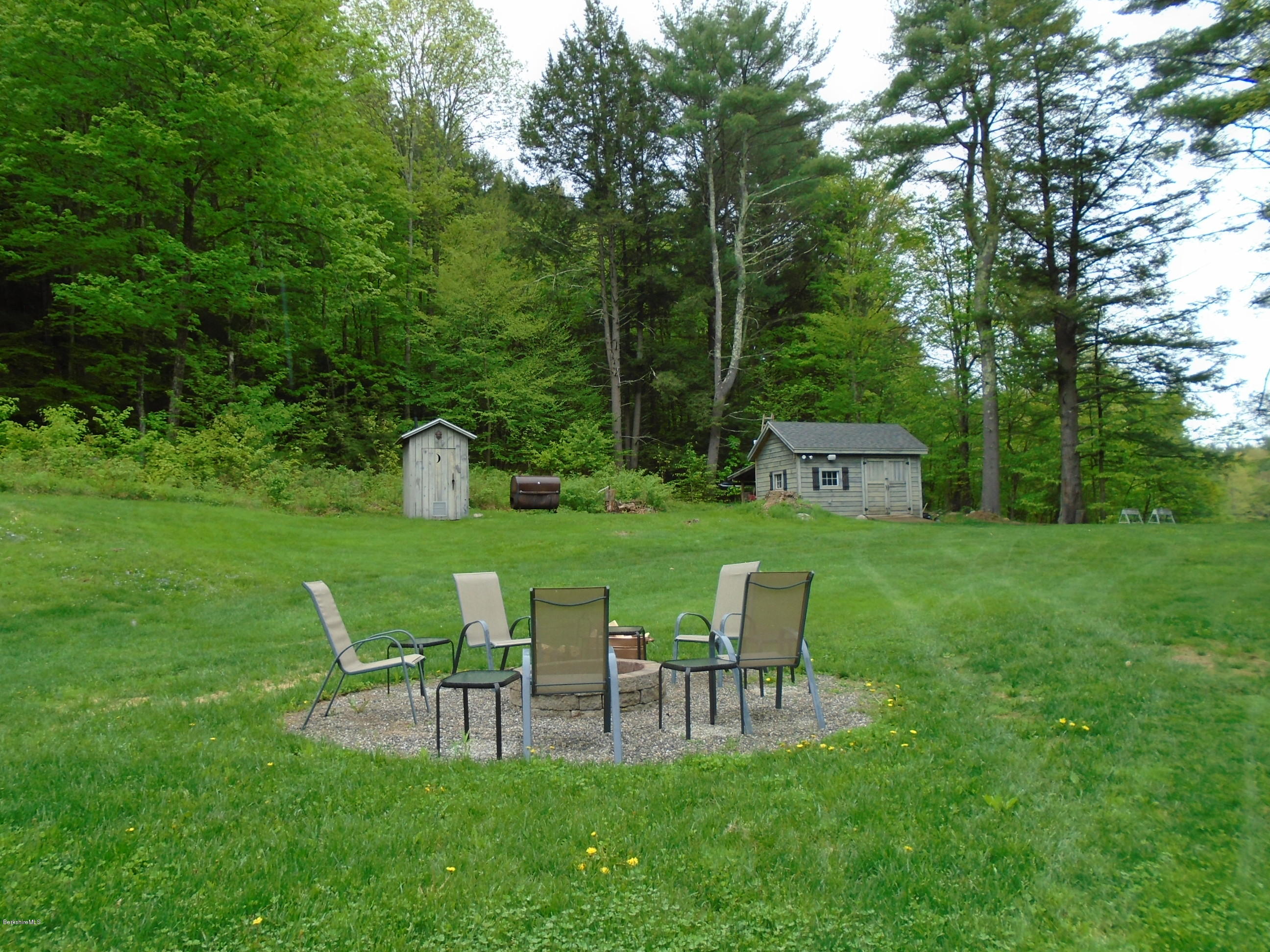 1350 South Main Road Otis, MA 01253 - Photo 52 of 56 a view of a chairs and table in a yard