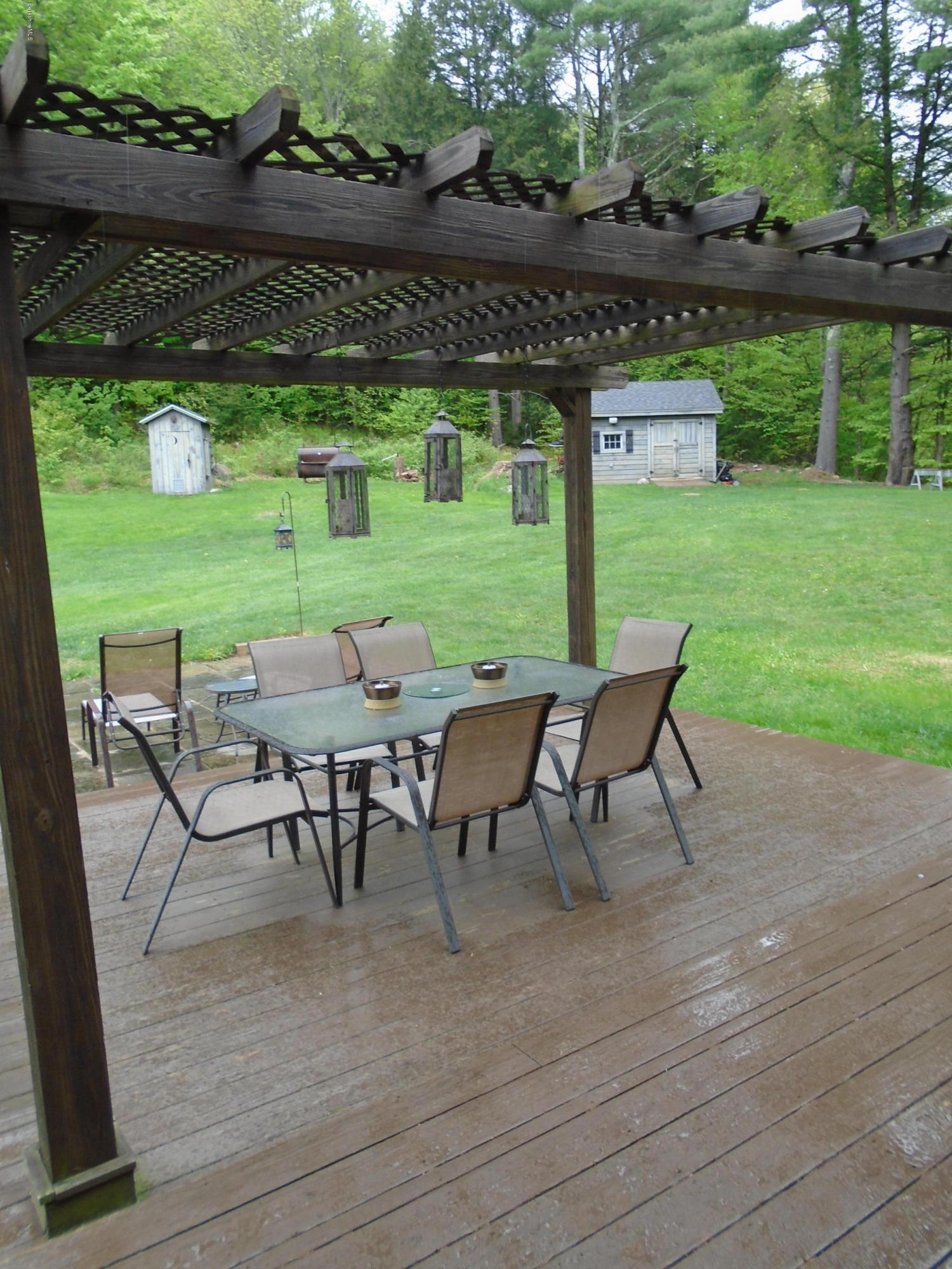 1350 South Main Road Otis, MA 01253 - Photo 53 of 56 a view of a chairs and table in patio with a yard