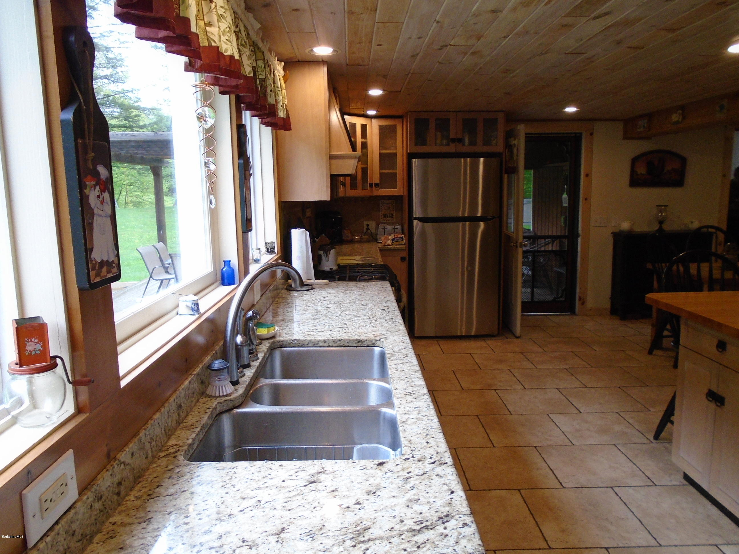1350 South Main Road Otis, MA 01253 - Photo 7 of 56 a view of a hallway with furniture and a refrigerator