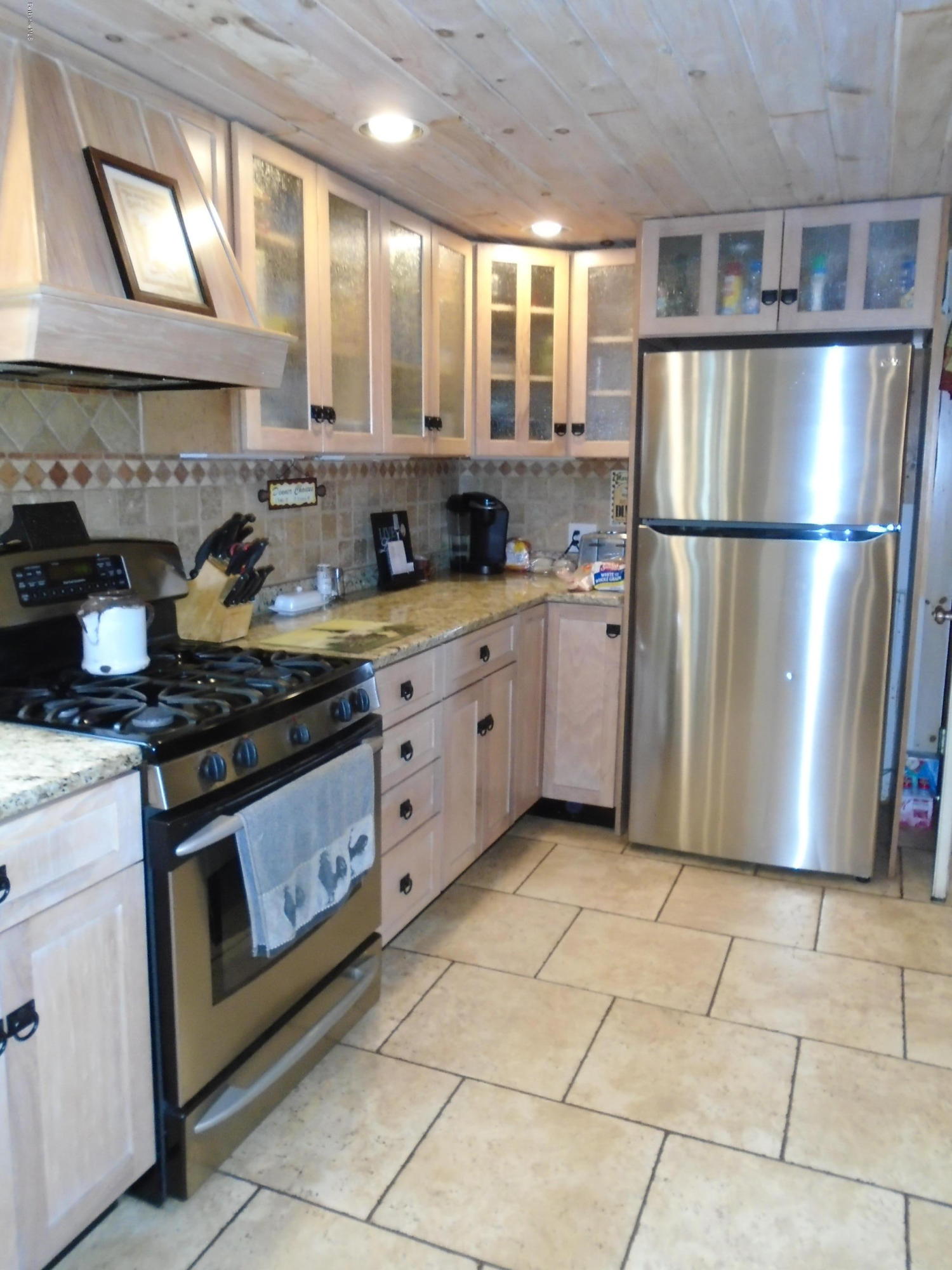 1350 South Main Road Otis, MA 01253 - Photo 9 of 56 a kitchen with stainless steel appliances granite countertop a stove a sink and a refrigerator