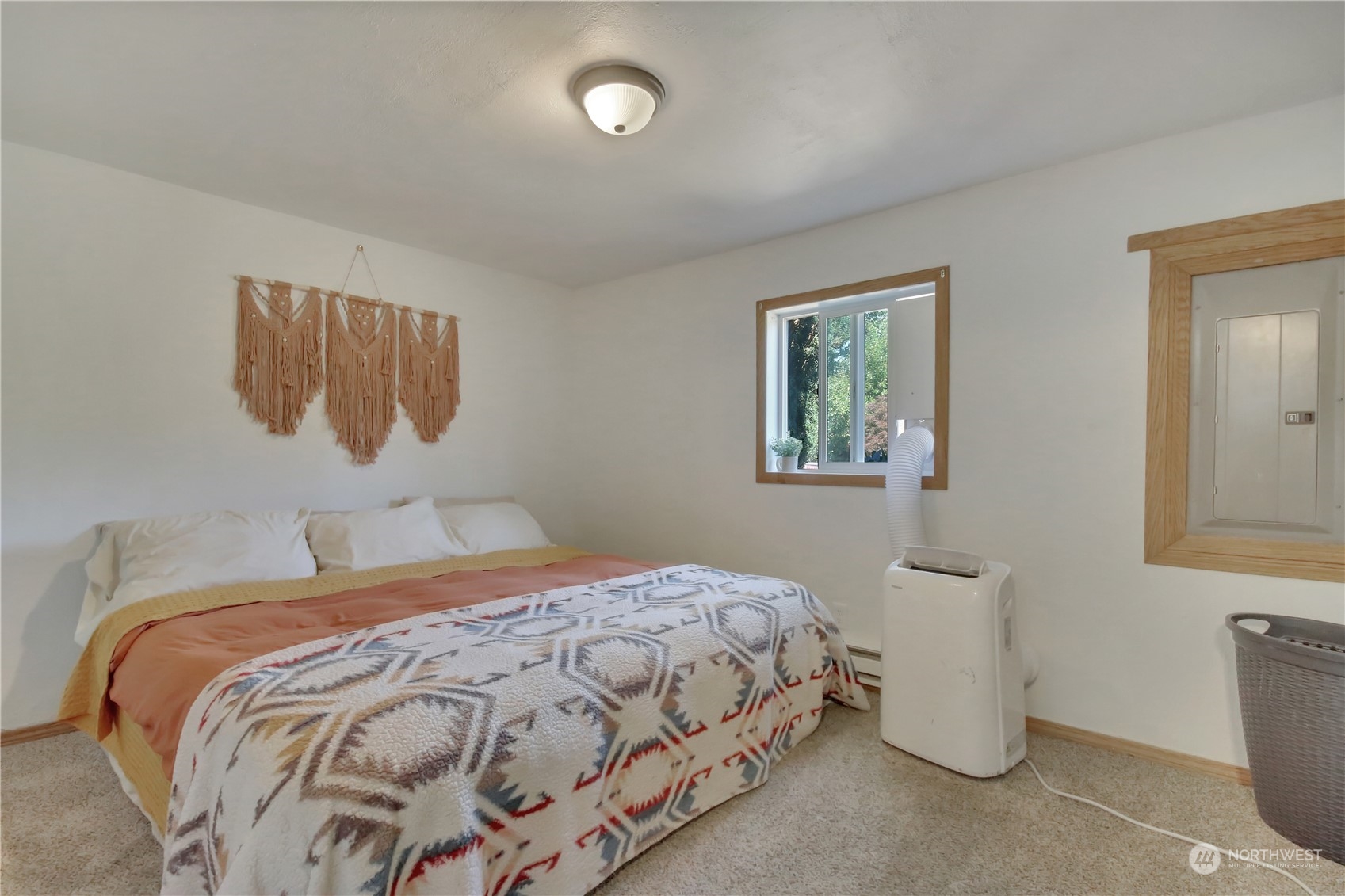 10920 Todd Road East Puyallup, WA 98372 - Photo 9 of 13 a bedroom with a bed and a painting on the wall