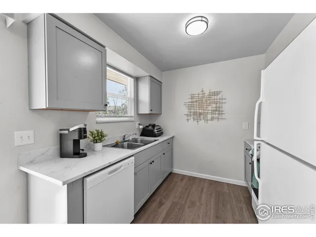a kitchen with sink cabinets and refrigerator