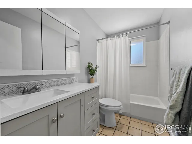 a bedroom with a bed and a lamp