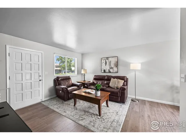 a dining room with furniture and wooden floor