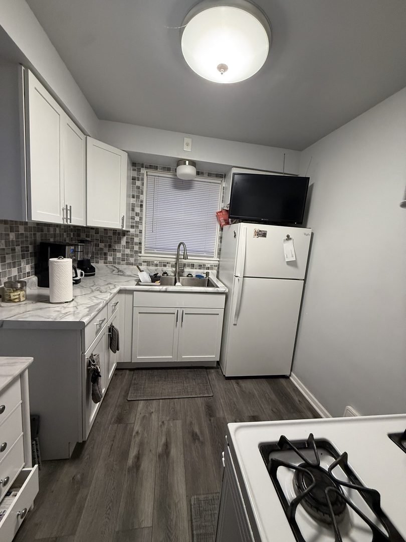2610 West 80th Street Chicago, IL 60652 - Photo 11 of 27 a kitchen with a sink a stove and cabinets