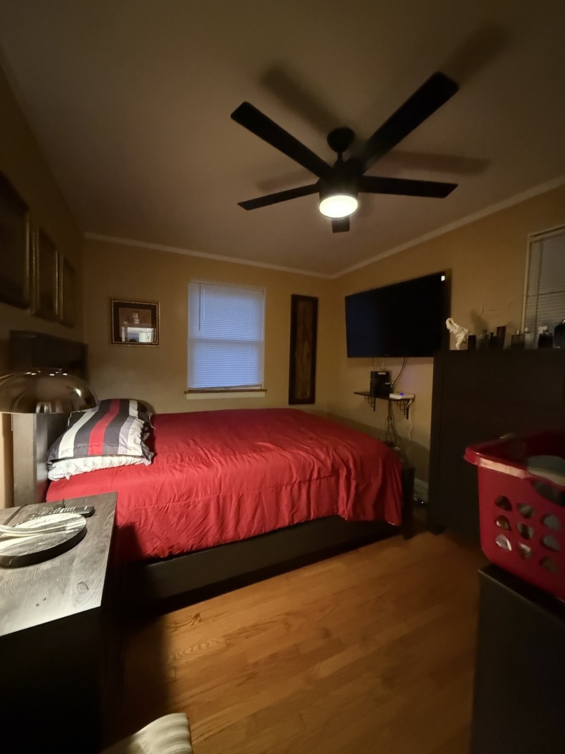 2610 West 80th Street Chicago, IL 60652 - Photo 14 of 27 a bed room with a bed and a lamp