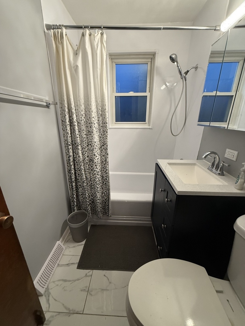 2610 West 80th Street Chicago, IL 60652 - Photo 15 of 27 a bathroom with a sink a toilet a window and vanity