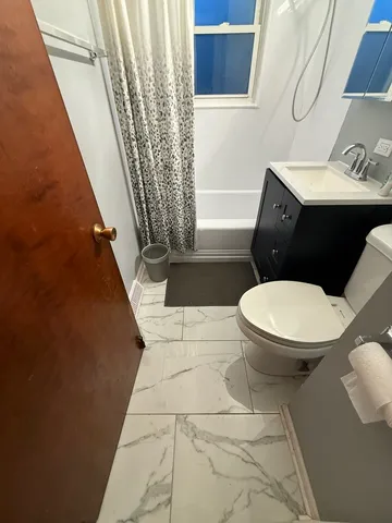 a white toilet sitting next to a small bathroom