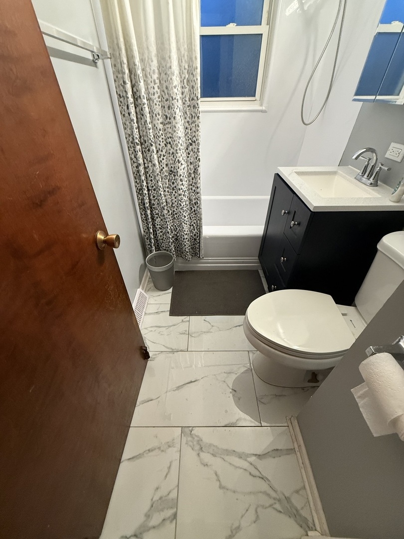 2610 West 80th Street Chicago, IL 60652 - Photo 17 of 27 a white toilet sitting next to a small bathroom