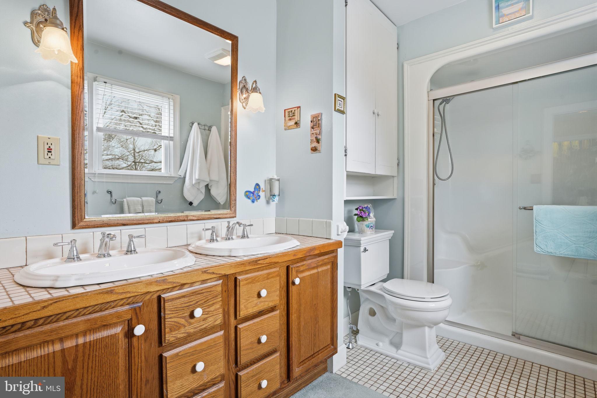 211 Longview Avenue Langhorne, PA 19047 - Photo 35 of 62 a spacious bathroom with a granite countertop sink toilet a shower and a mirror