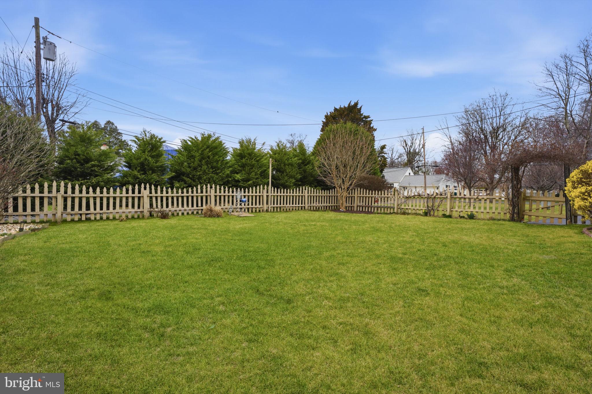 211 Longview Avenue Langhorne, PA 19047 - Photo 43 of 62 a view of a park with large trees and a wooden fence