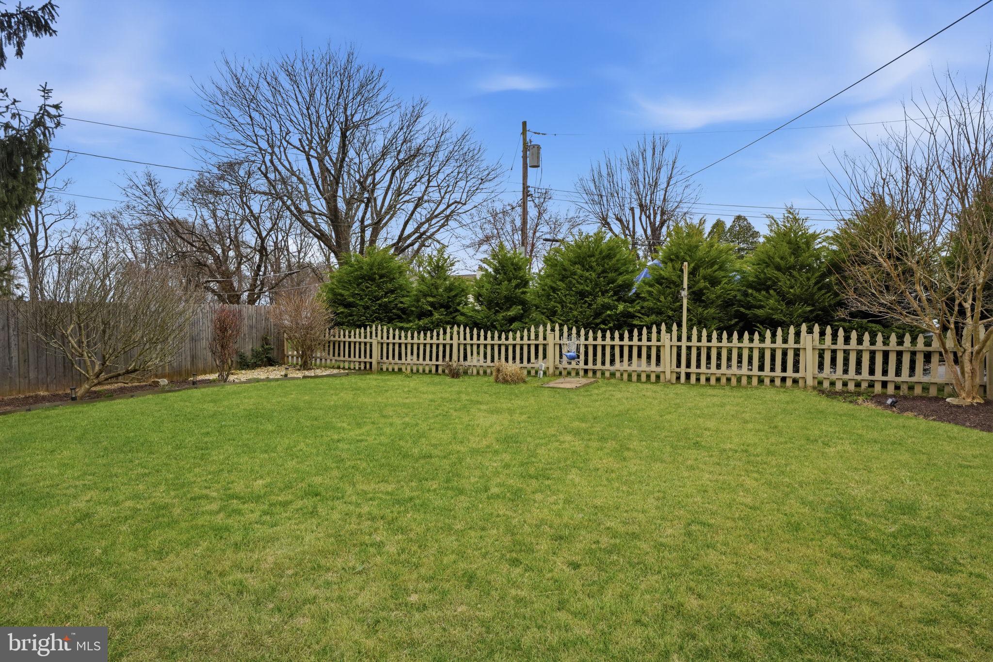 211 Longview Avenue Langhorne, PA 19047 - Photo 45 of 62 Lush green yard with rustic fencing.