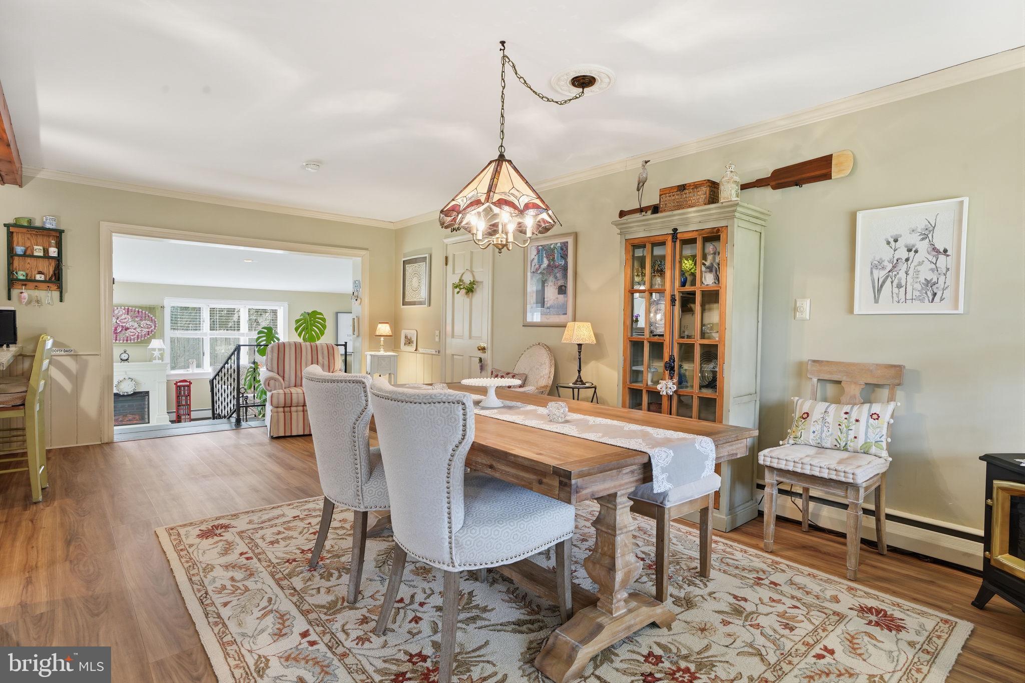211 Longview Avenue Langhorne, PA 19047 - Photo 7 of 62 a dining room with wooden floor a chandelier a wooden table and chairs